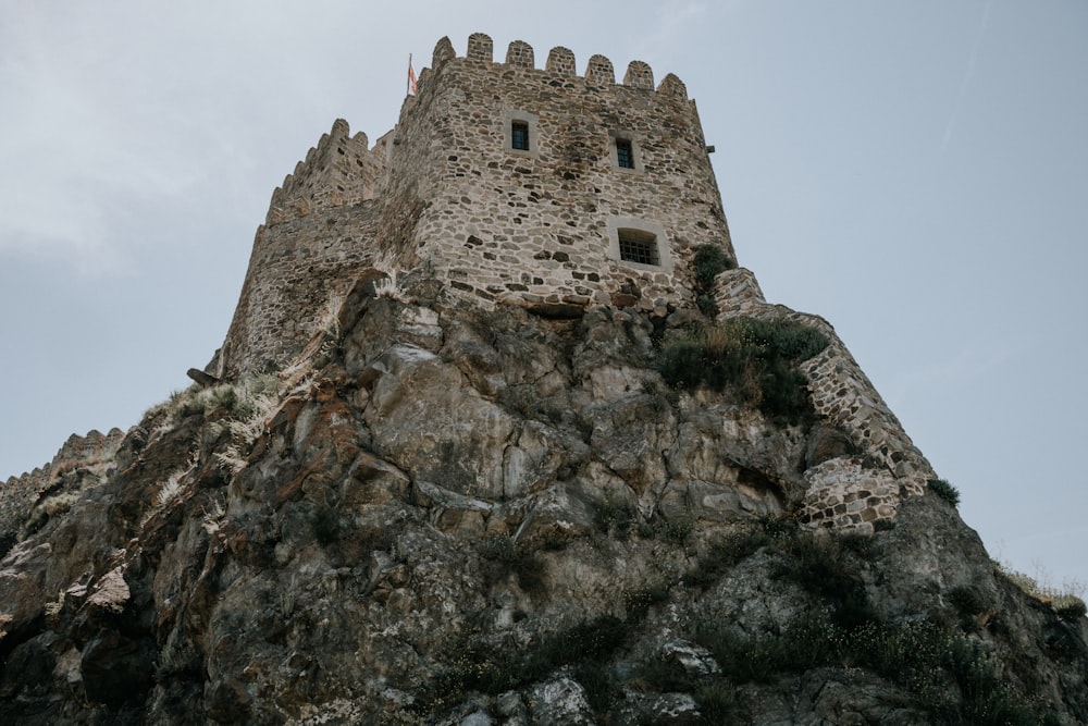 a stone castle on a rocky hill