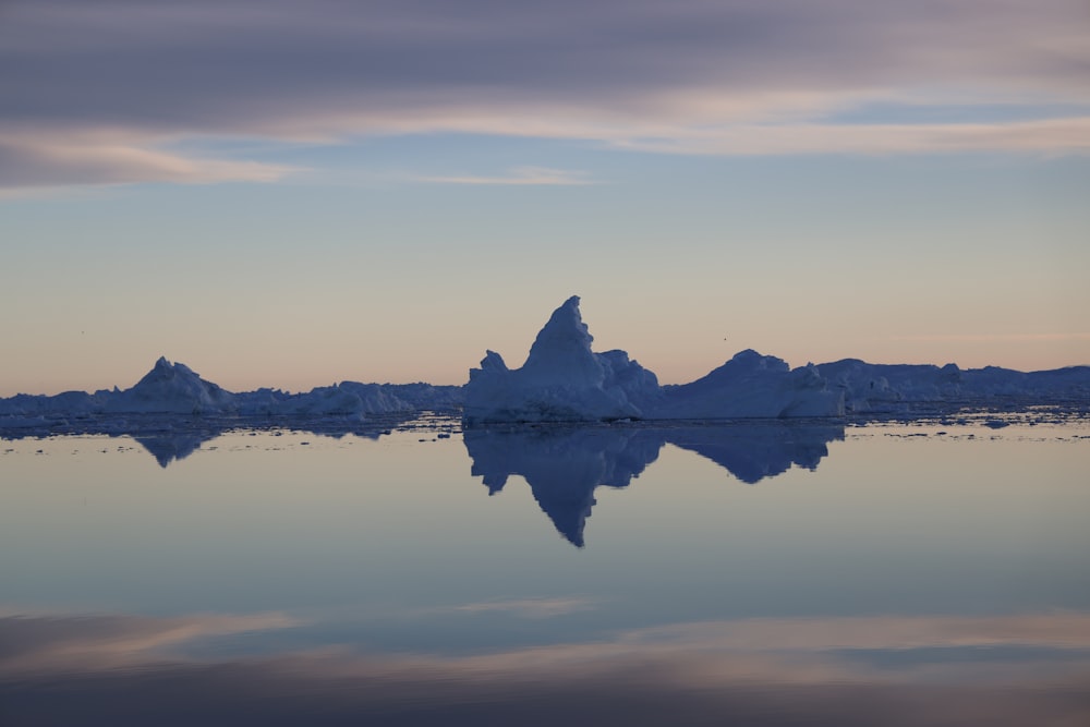 a body of water with a mountain in the distance