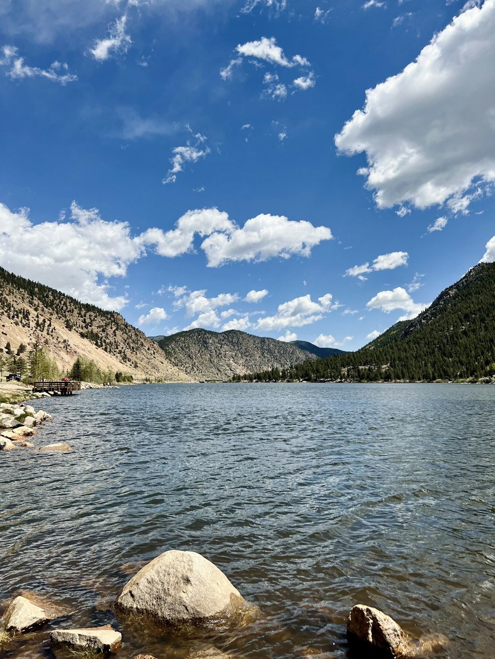 a body of water with mountains in the background