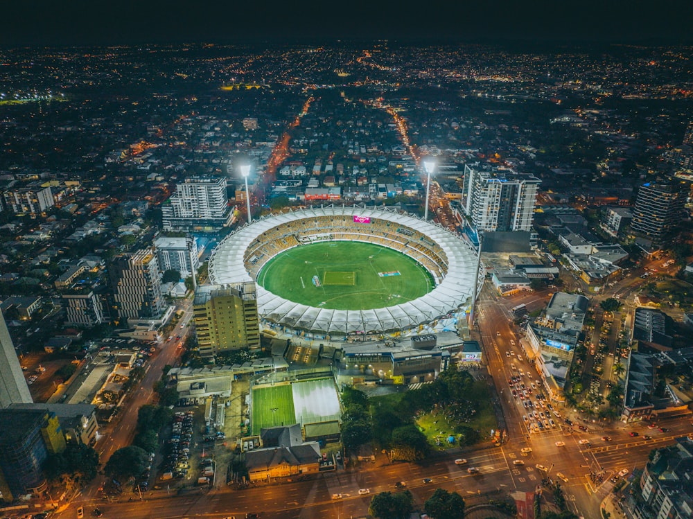 a large stadium with a field in the middle of a city