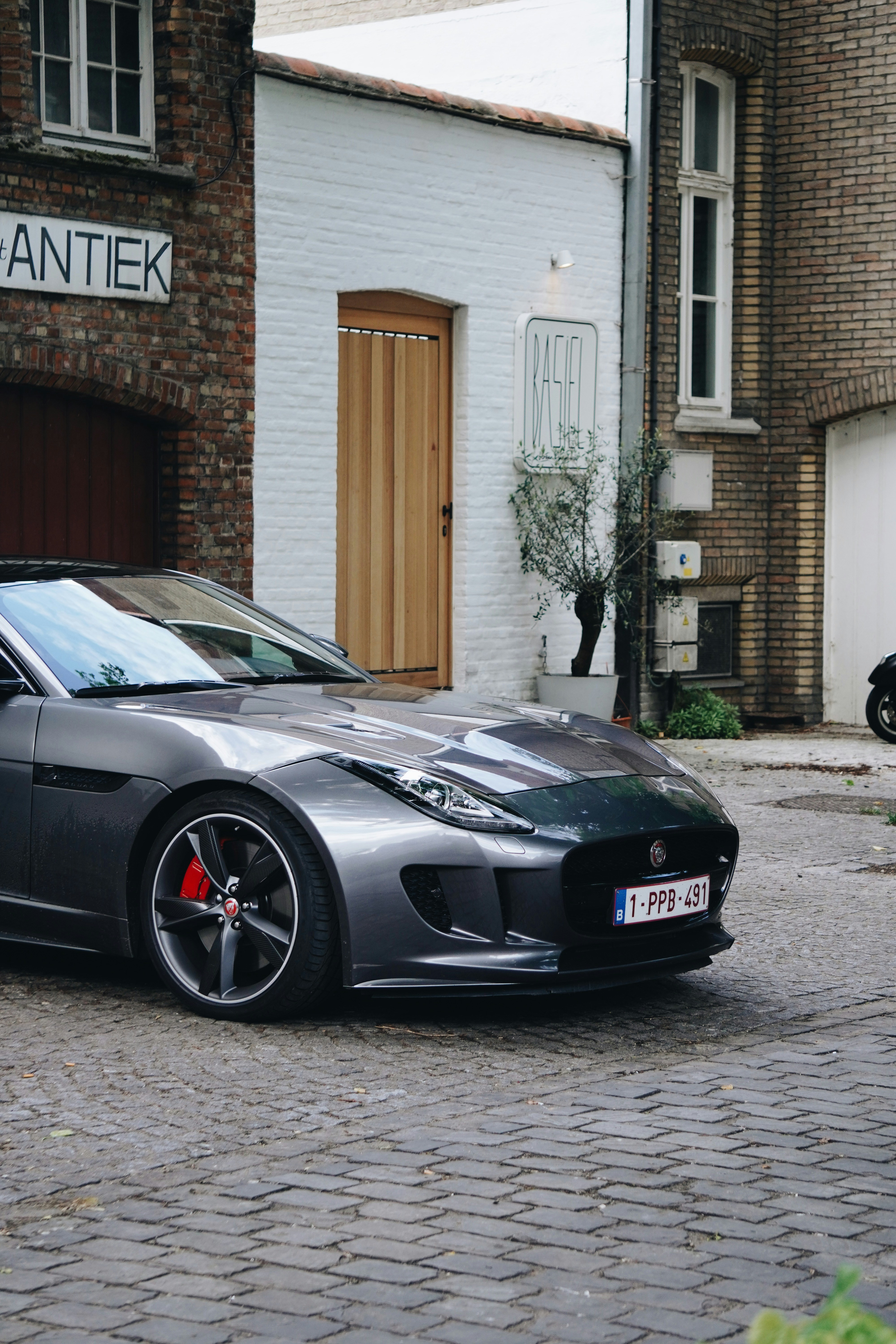A black car parked in front of a house photo – Free Automobile Image on ...