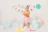 A joyful little girl wearing a handmade pastel bow at her birthday party.