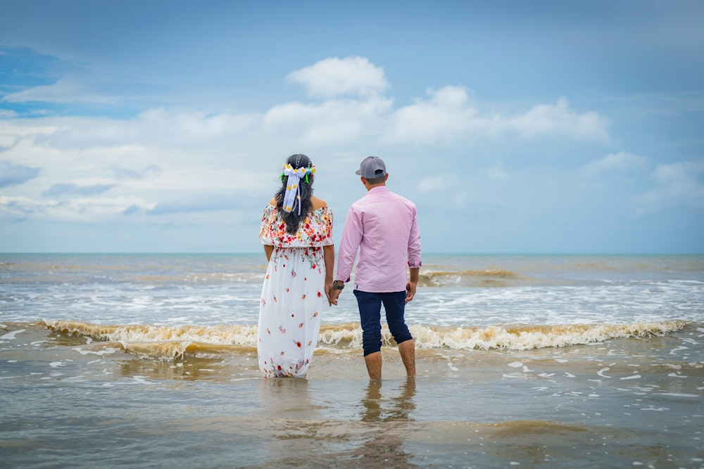 a man and woman walking in the water