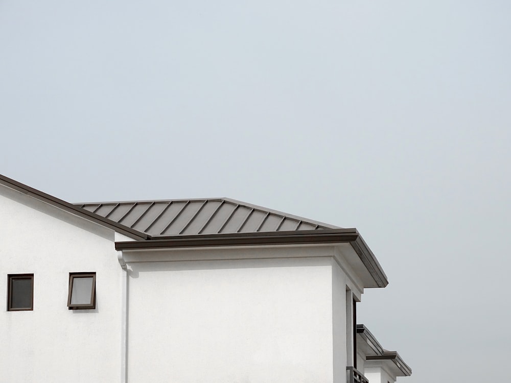 a white building with a black roof