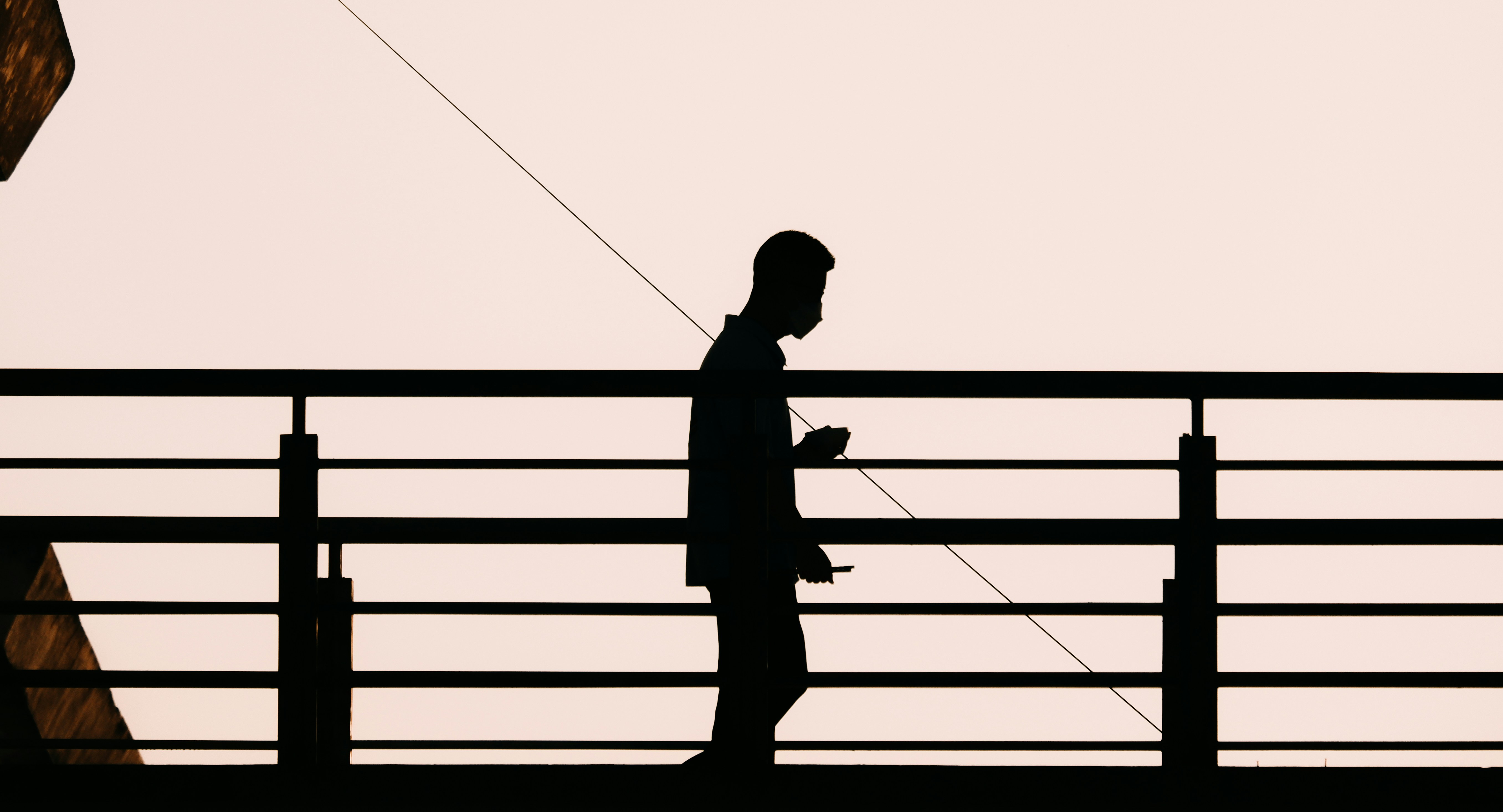 a silhouette of a person standing on a balcony