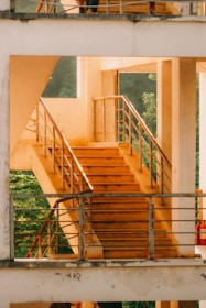 A clean, well-maintained metal handrail along a sunny outdoor staircase.