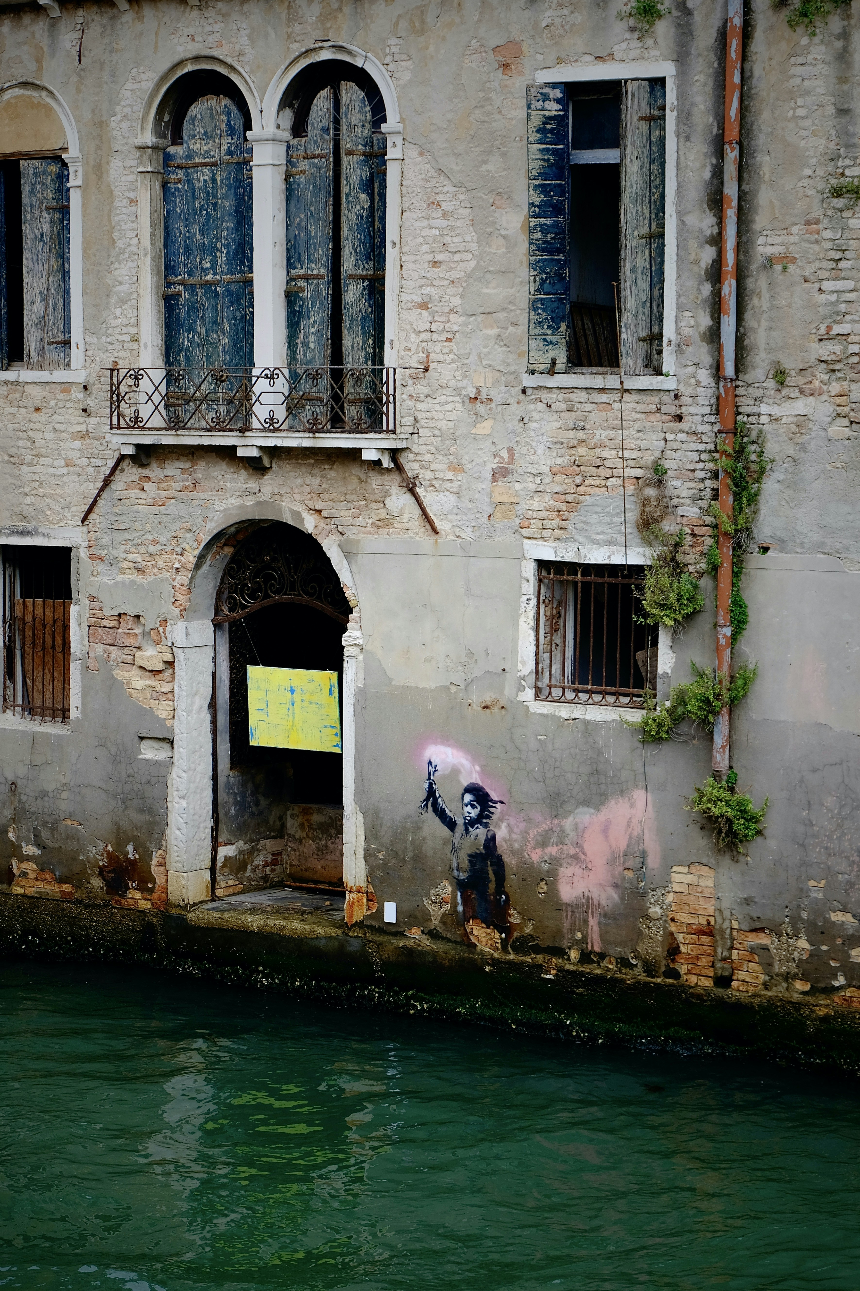 a building with a couple of people standing on the side of it