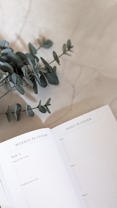 A minimalist digital planner open on a soft muted background with subtle geometric patterns.