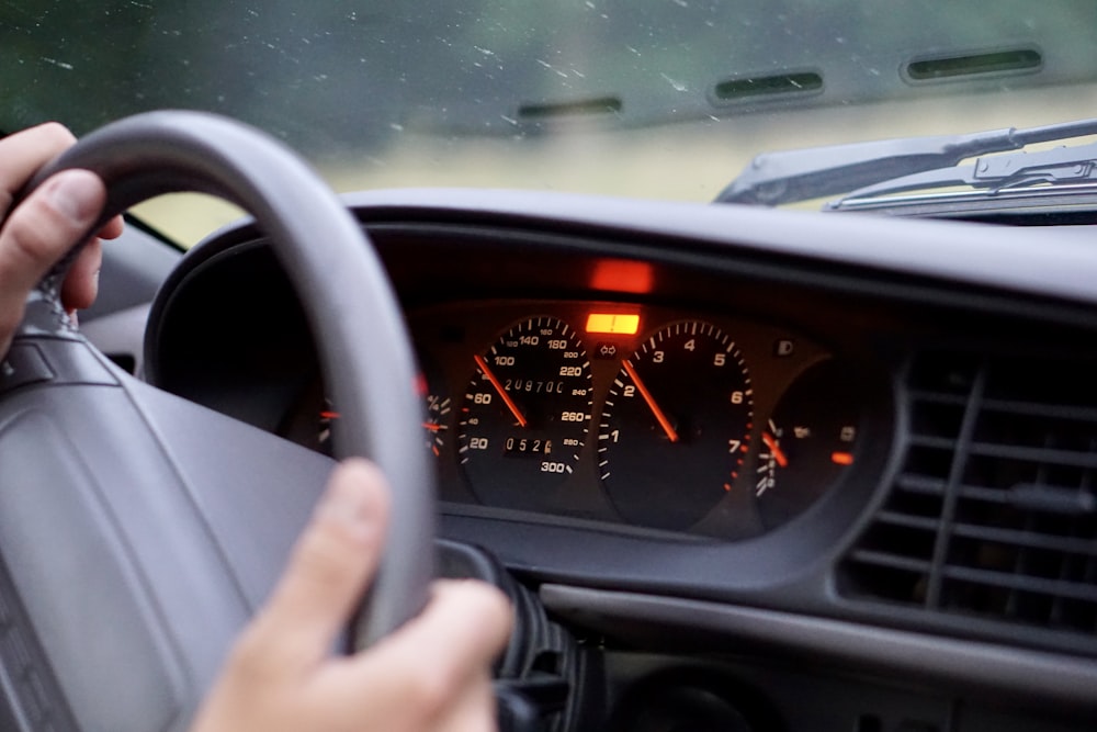 a person holding a steering wheel