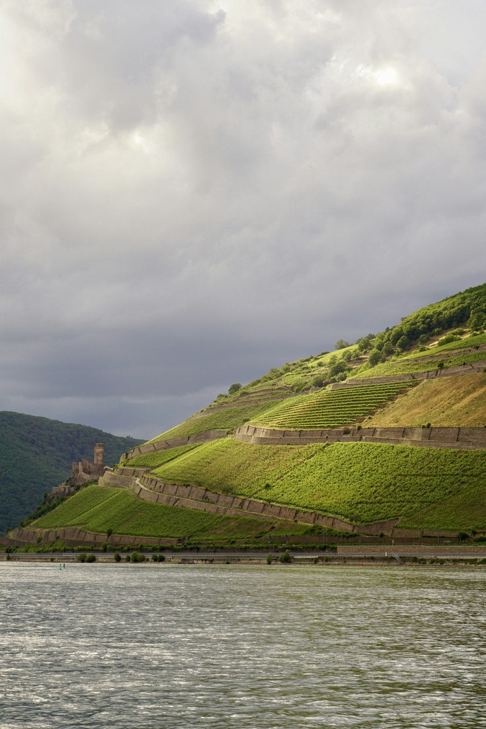 a body of water with hills in the back