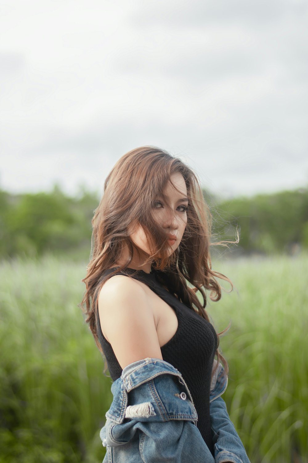 a woman sitting in a field