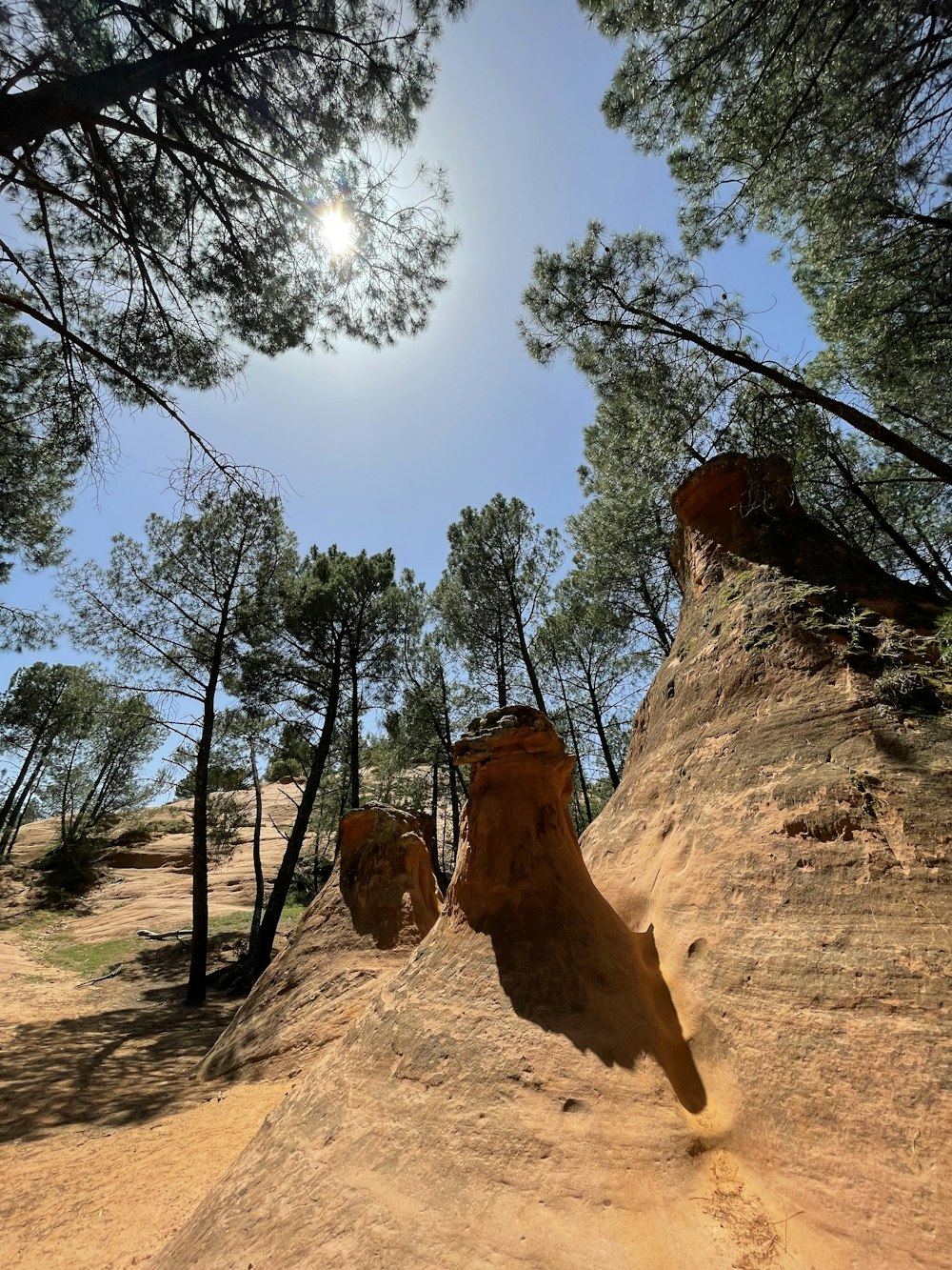 a large rock formation in the middle of a dirt road