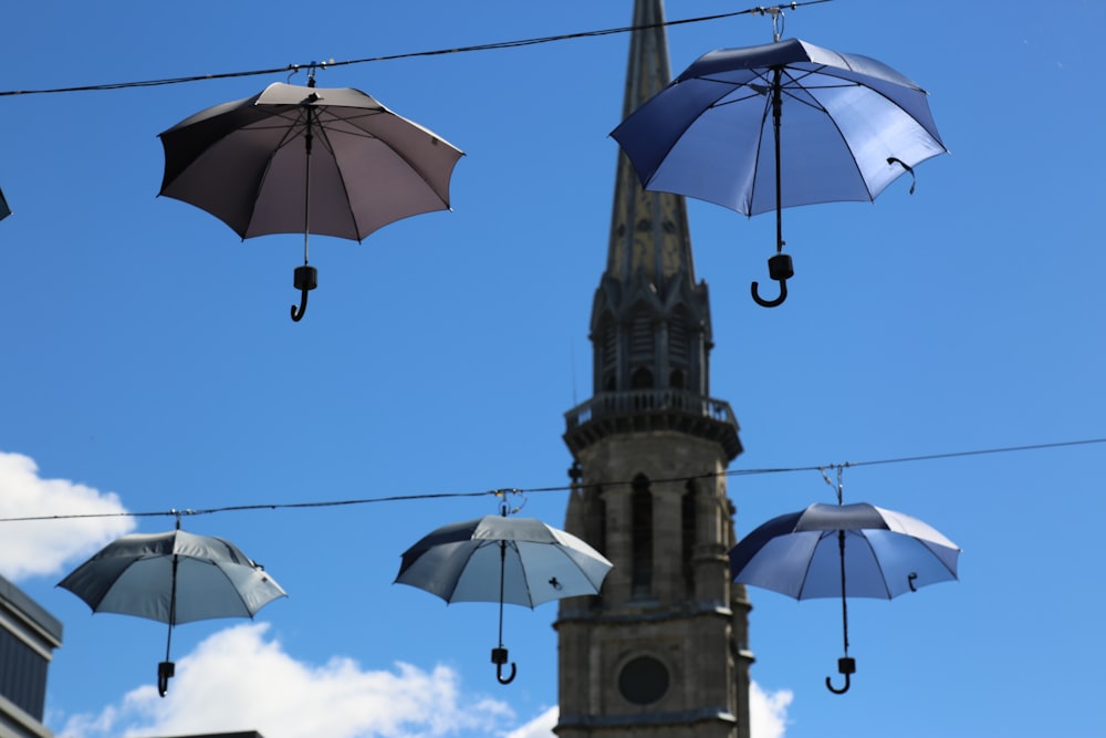 a group of umbrellas swing from a tower