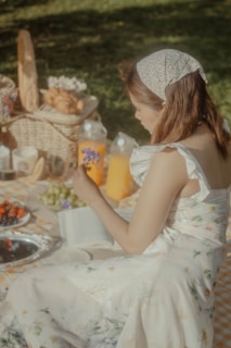 a person sitting at a table with food and drinks
