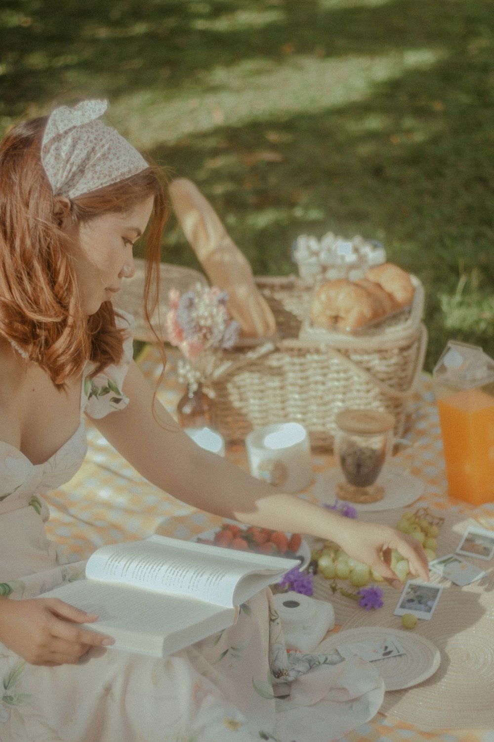 a woman sitting at a table with a basket of food and a basket of food