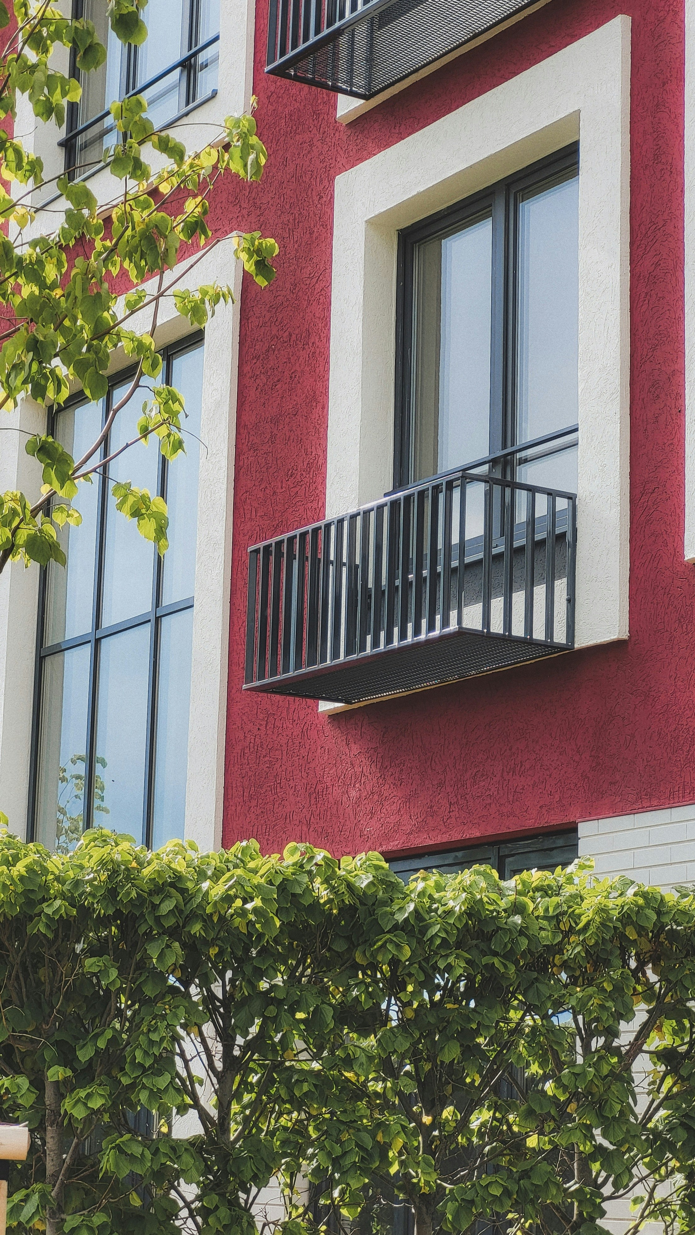 A red building with a black railing photo – Free Building Image on Unsplash
