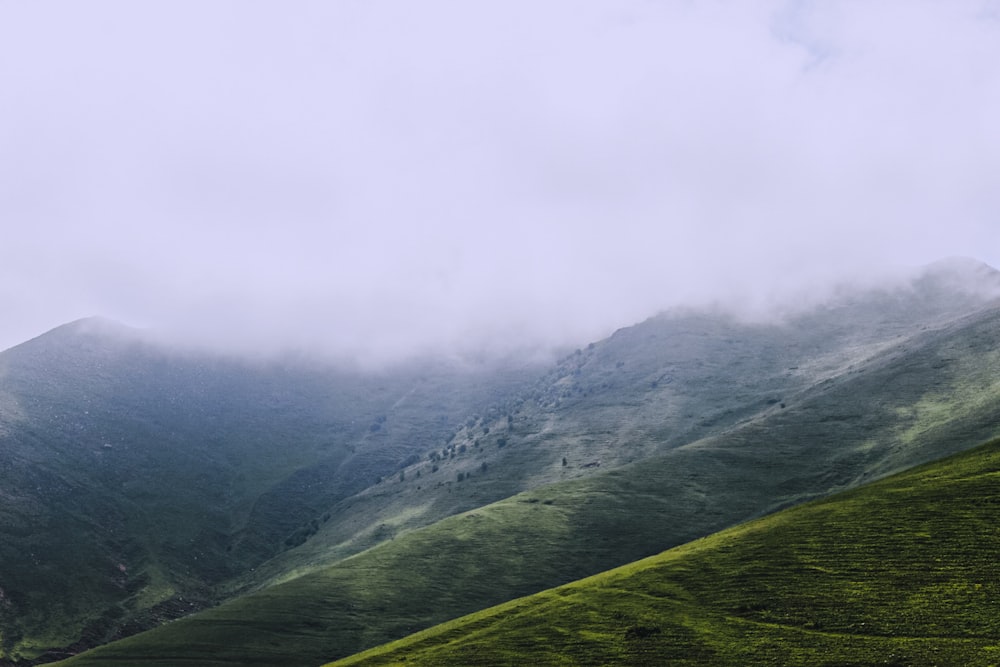 a valley with fog around it