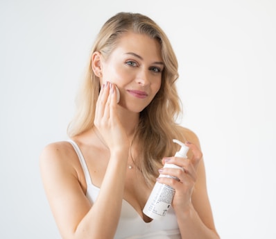 a woman holding a bottle
