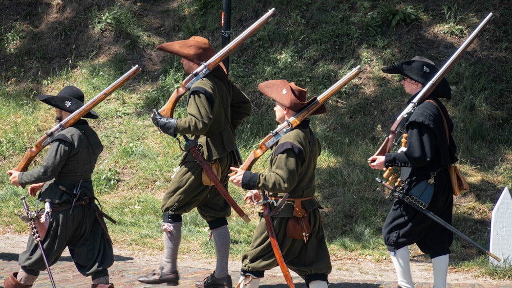 a group of men in military uniforms holding rifles