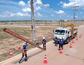 a group of people standing next to a truck on a road