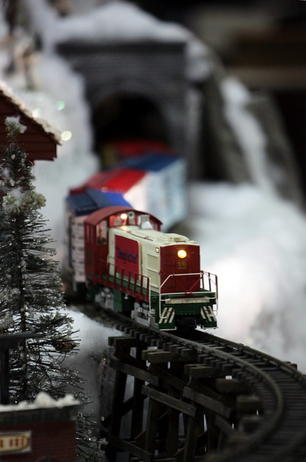 a train on a track with snow on the ground