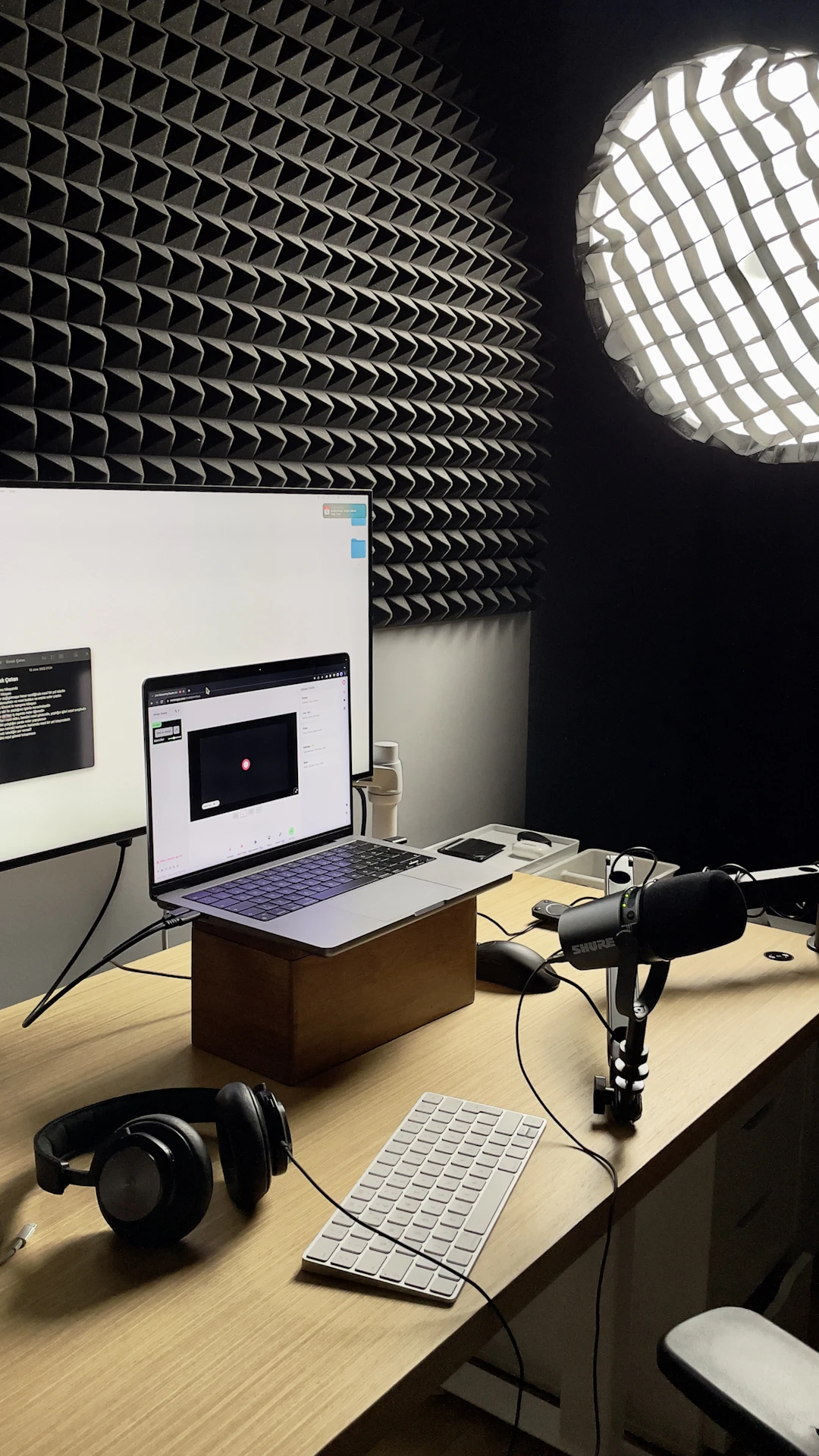Headphones and a laptop arranged on a work desk