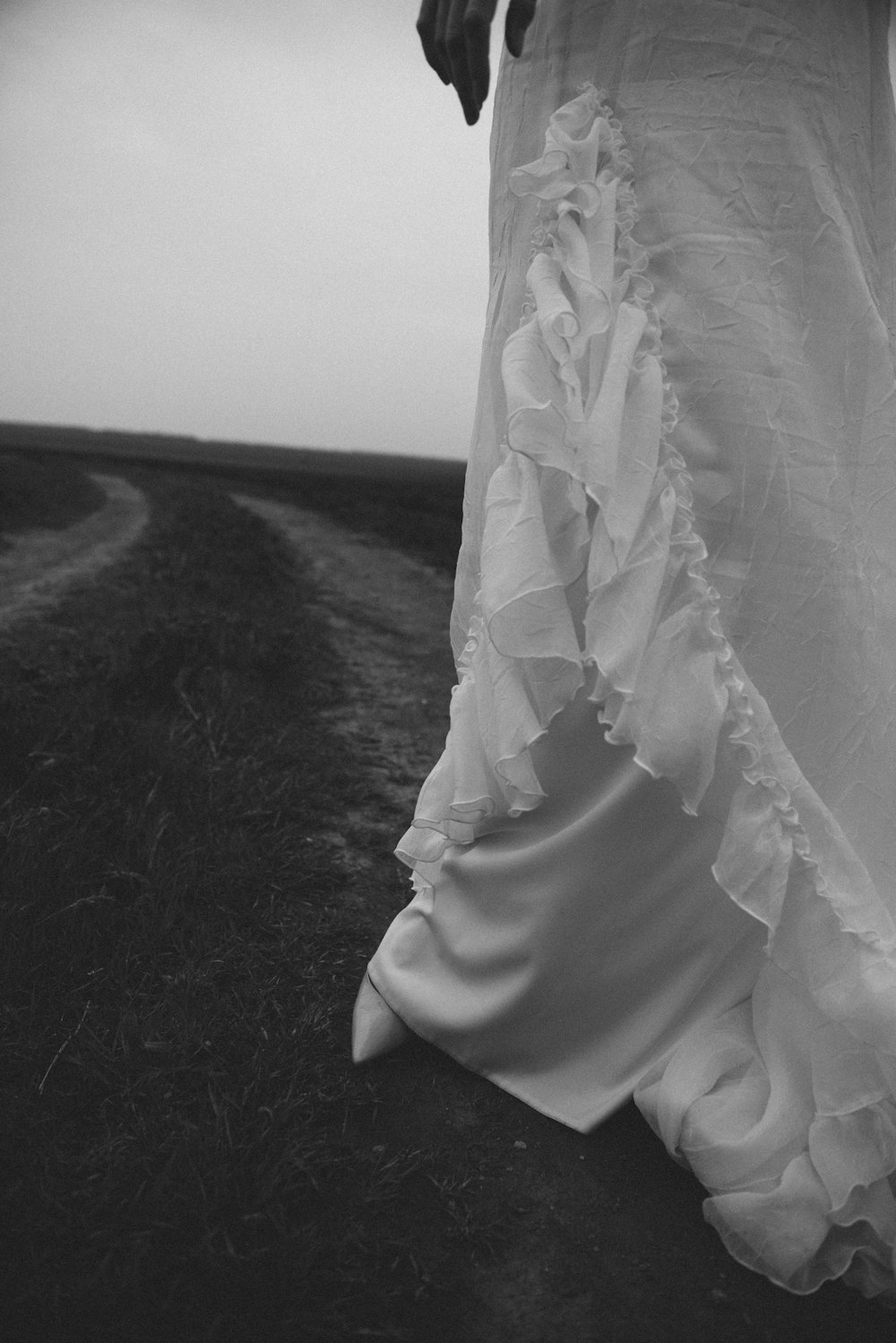 a woman's hand with a white dress on