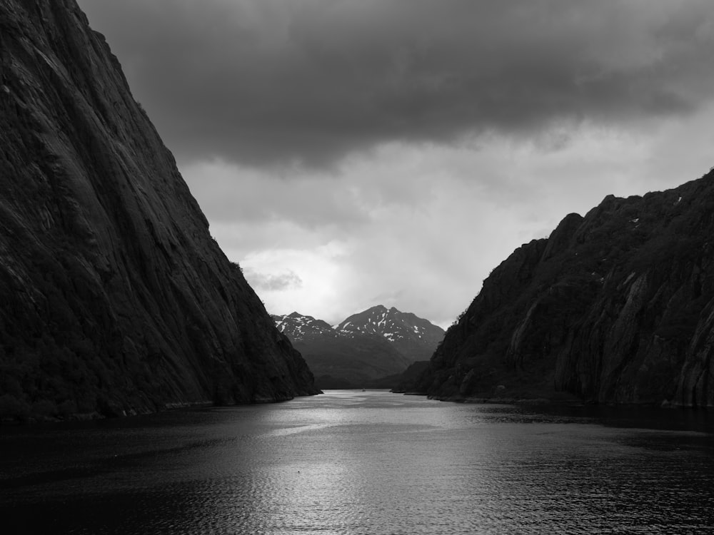 a body of water with mountains in the back