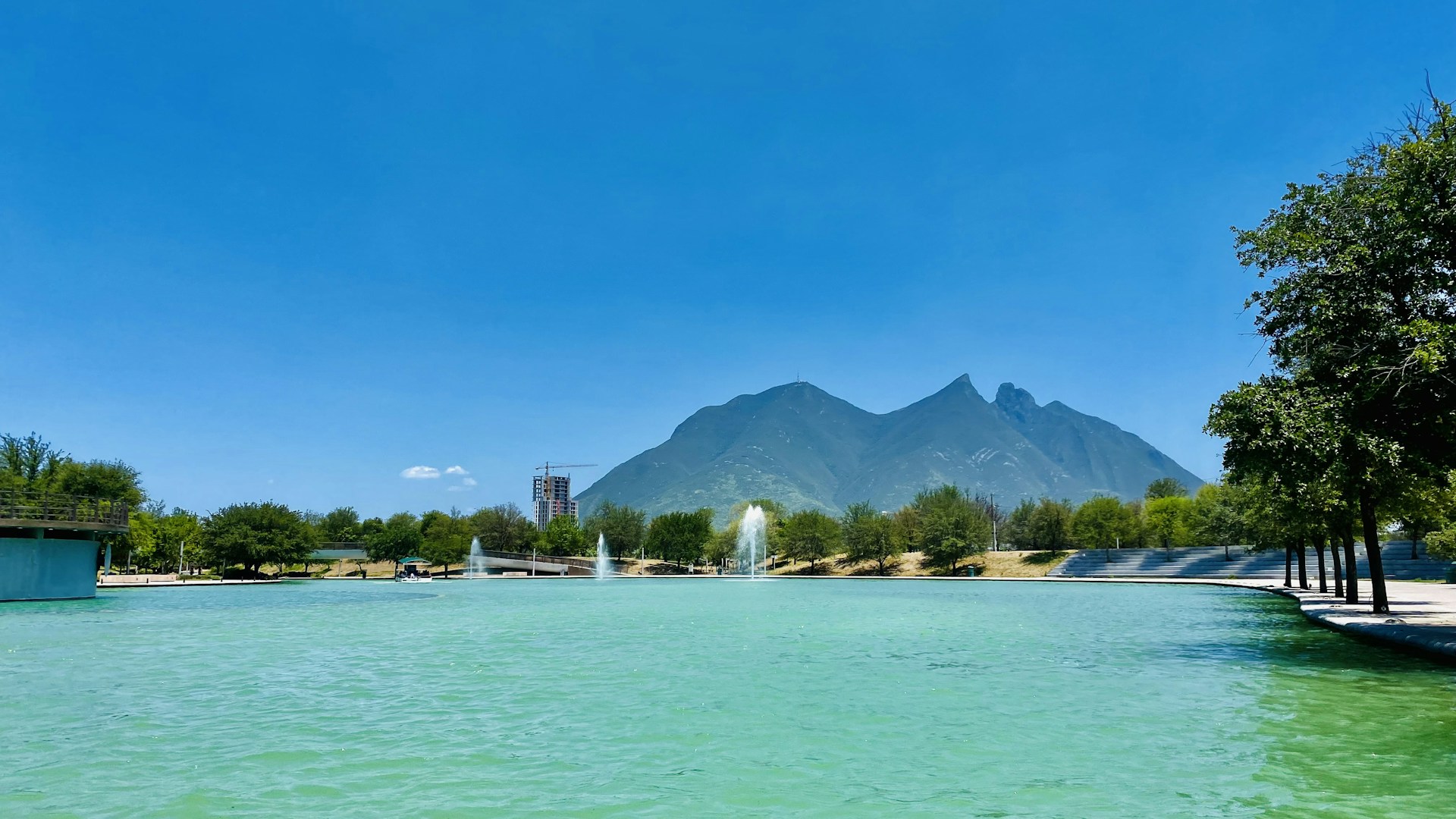 a body of water with a mountain in the background