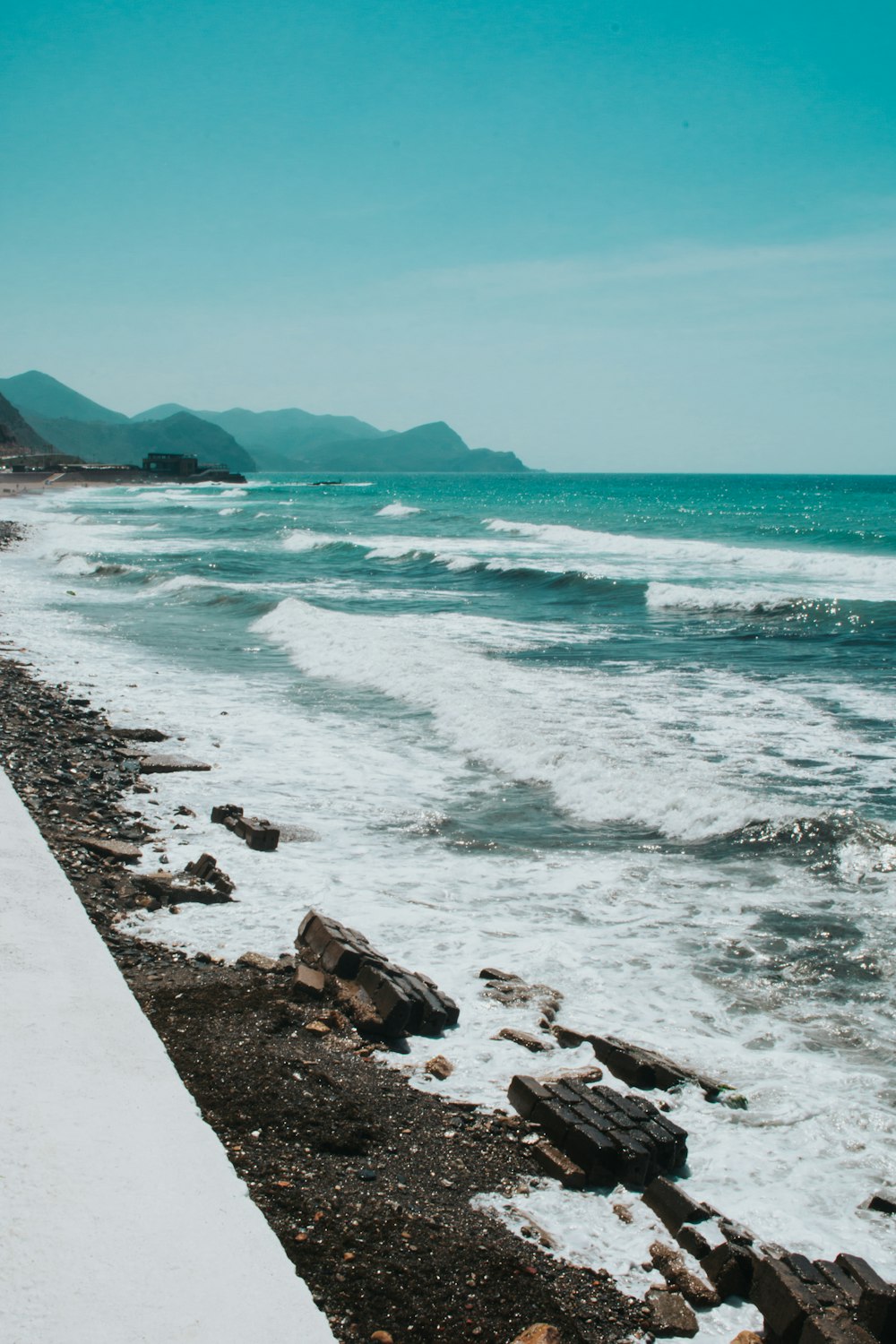 a rocky beach with waves crashing