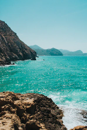 Turquoise waters gently lapping against the rocky coastline near Gozo.
