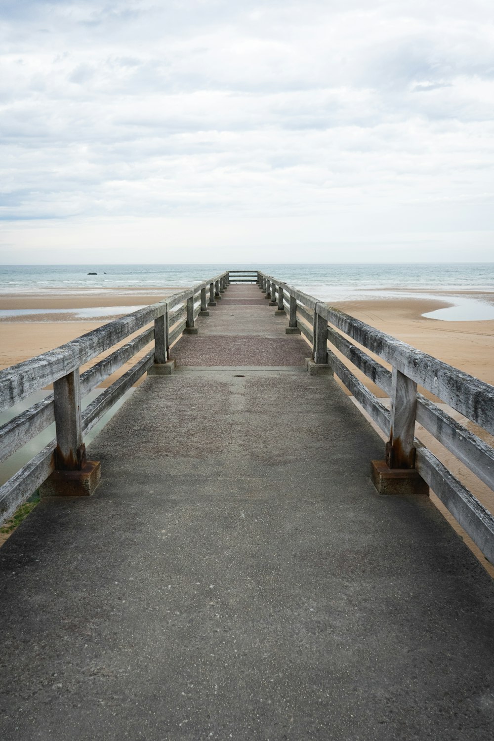 a long wooden walkway on a beach