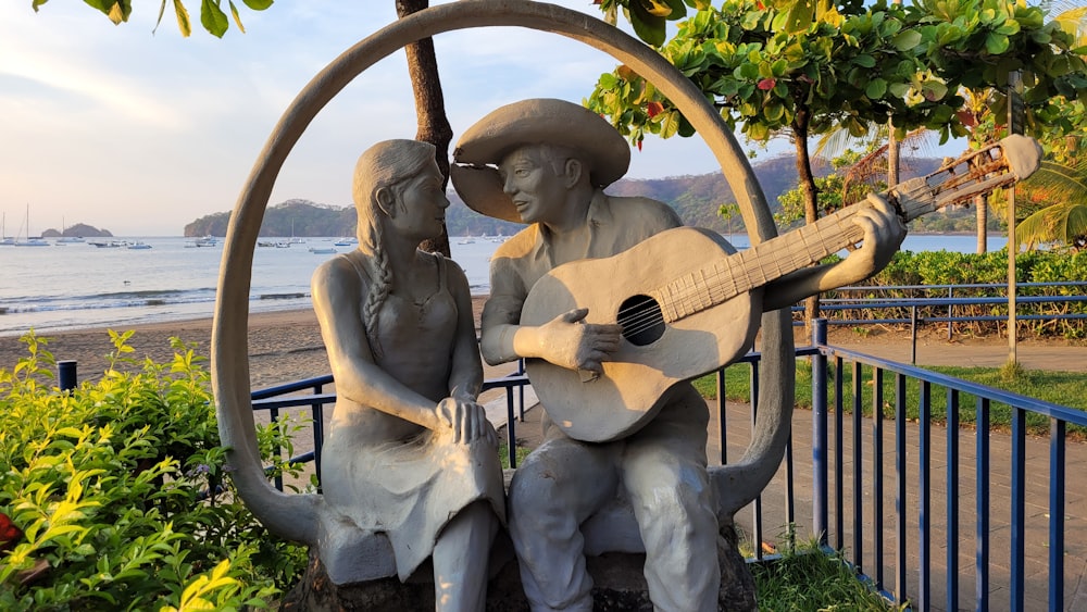 a statue of a man and a woman holding a gun