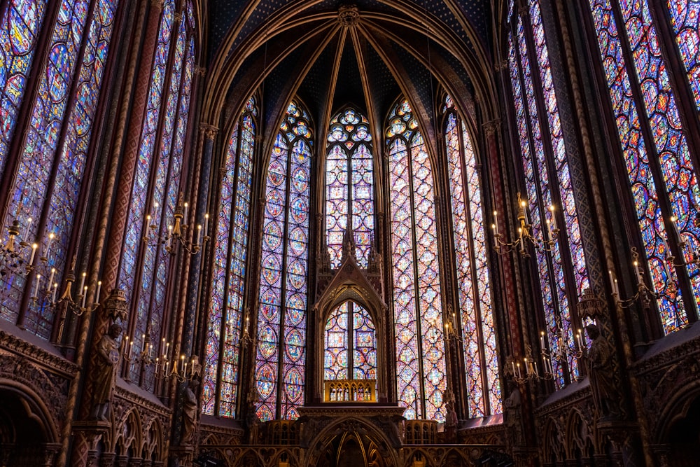 a large cathedral with stained glass windows with Sainte-Chapelle in the background