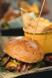 A close-up of a juicy halal burger served with fries.