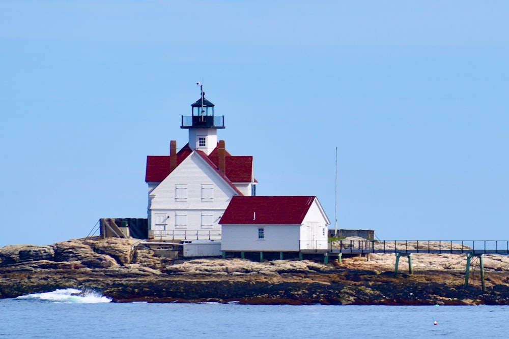 a white building on a rocky shore