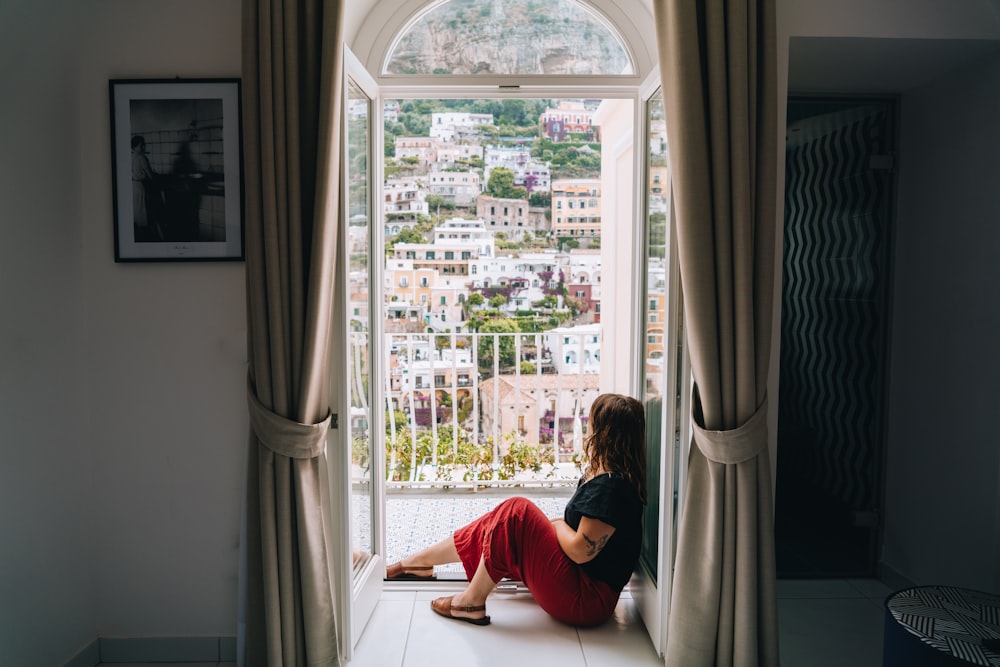 a person sitting on a window ledge