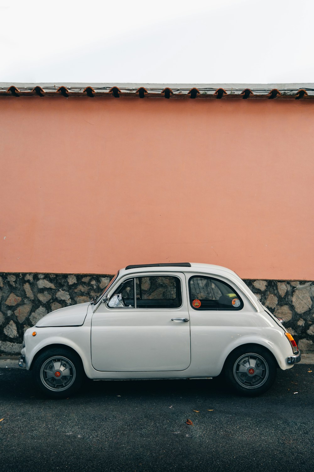 a car parked in front of a wall