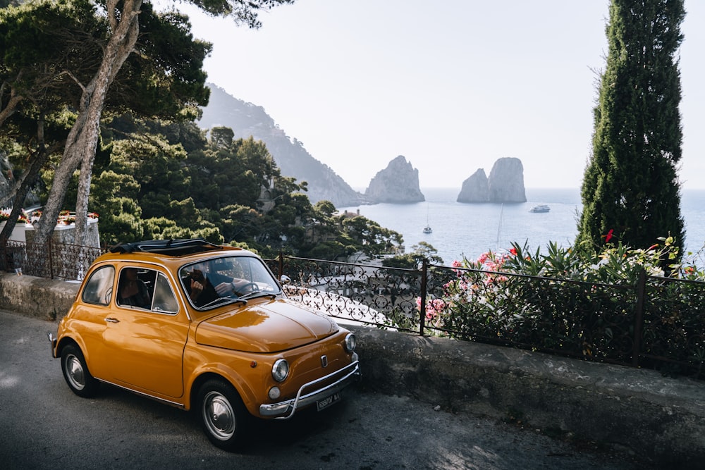 a car parked on a road by a body of water