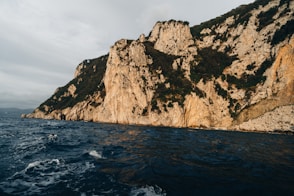 a cliff with a body of water below