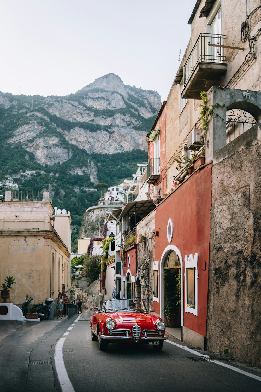 a red car parked on the side of a road