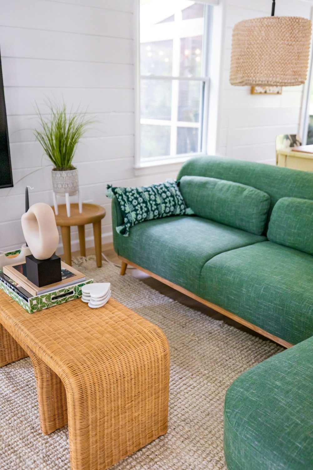 a living room with green couches