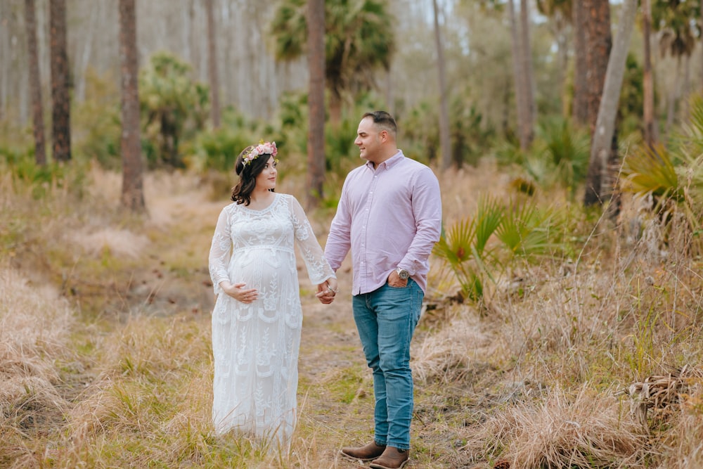 a man and woman walking in a field