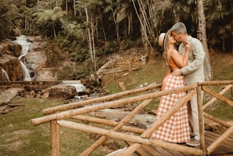Couple sharing a quiet moment together on a rustic wooden bridge