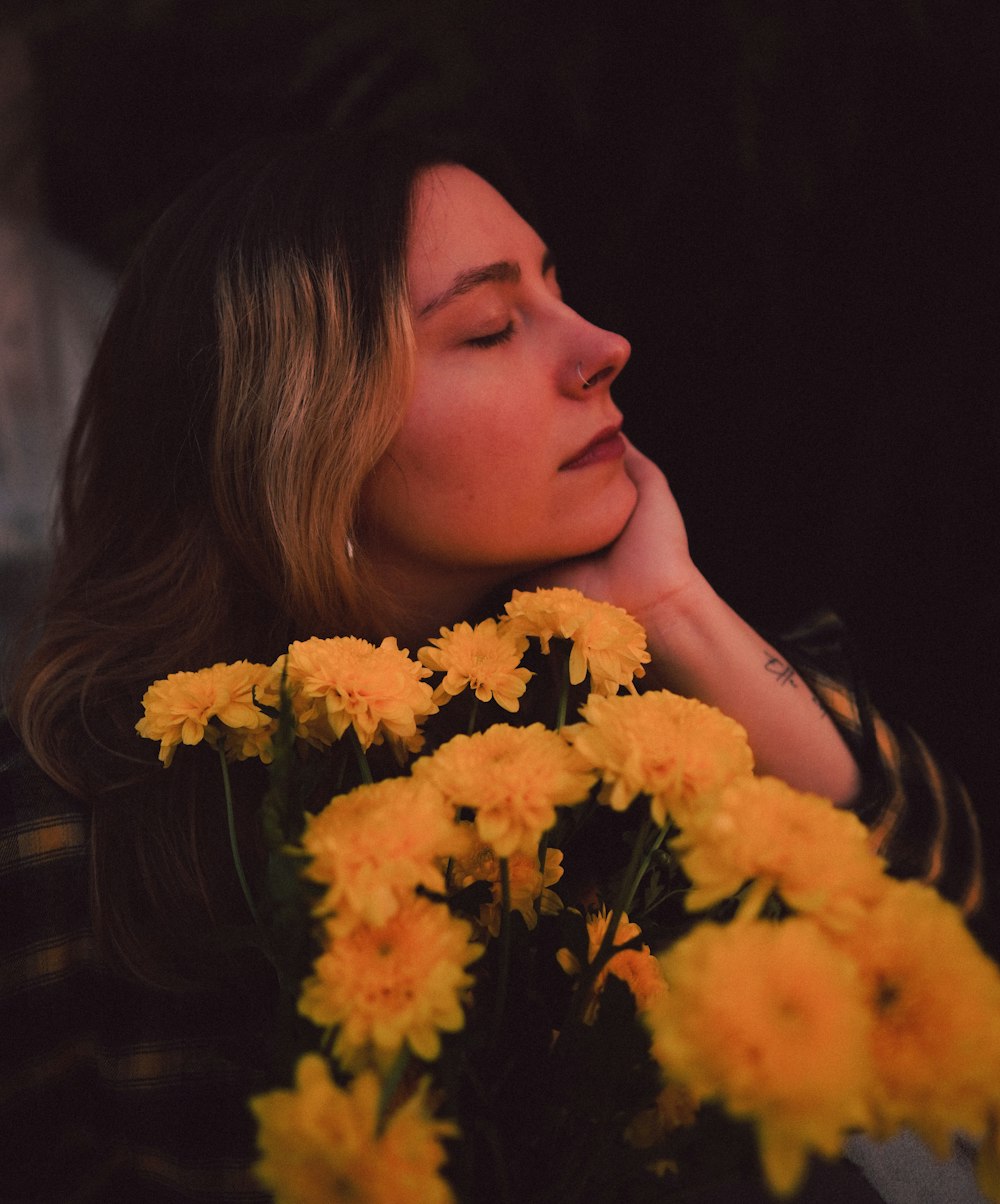 a woman smelling flowers