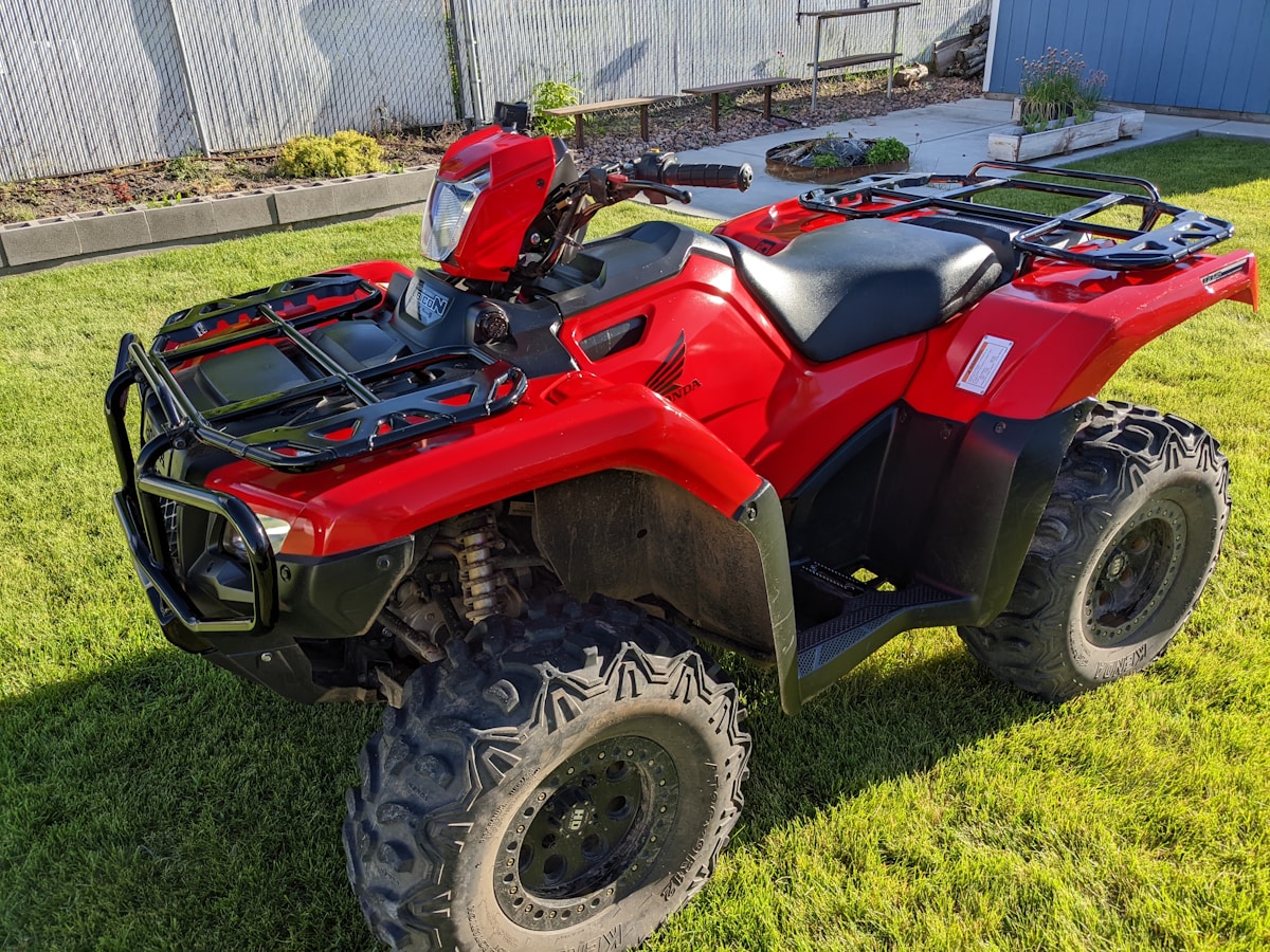 Honda ATV in a back yard listed for sale