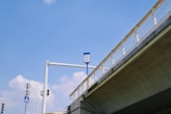 A large gantry board installed over a busy national highway with clear, reflective signage.
