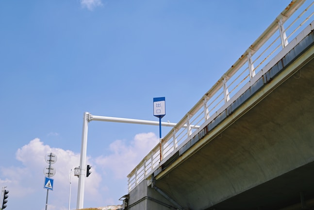 A large gantry board installed over a busy national highway with clear, reflective signage.