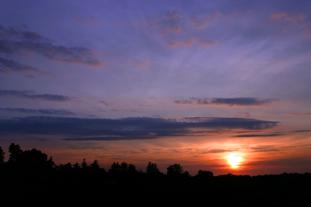 a sunset over trees