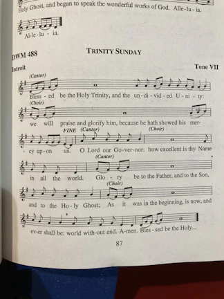 Congregation members singing joyfully together with hymnals open on a peaceful morning